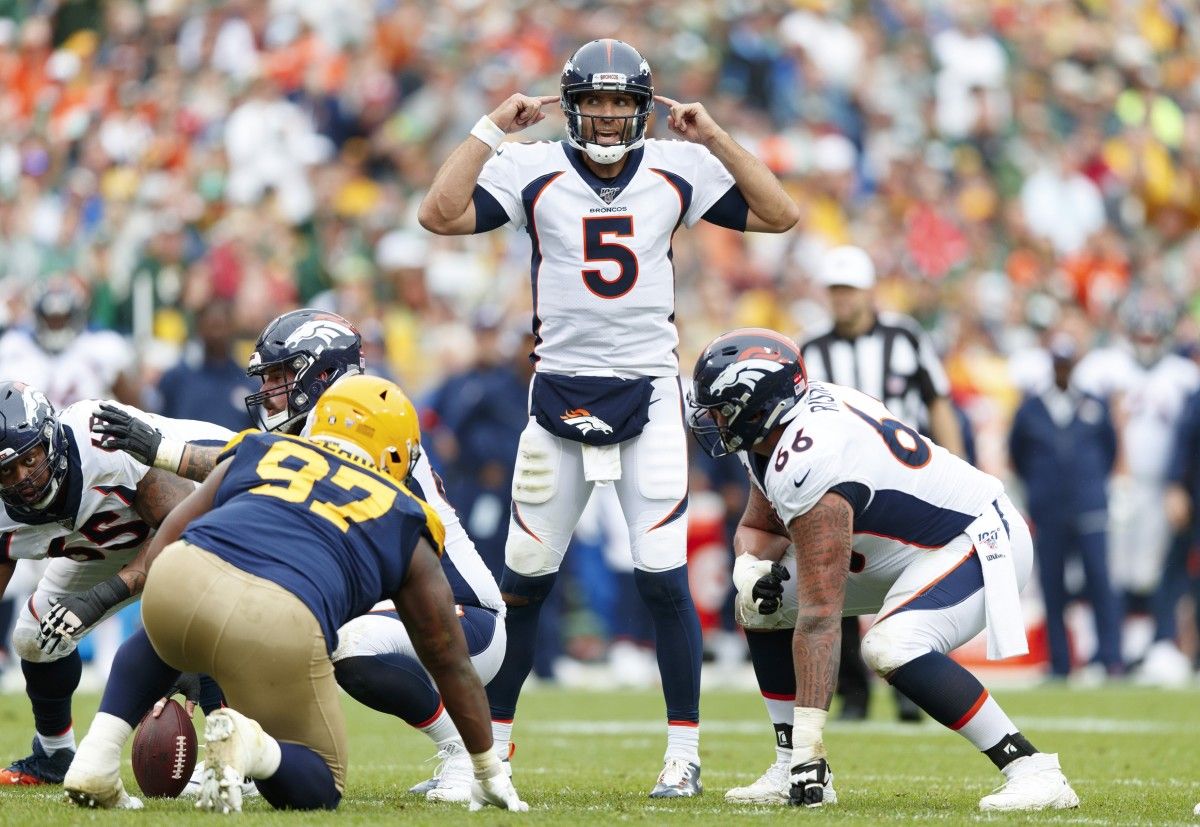 Denver Broncos quarterback Joe Flacco (5) signals prior to a play during the second quarter against the Green Bay Packers at Lambeau Field.
