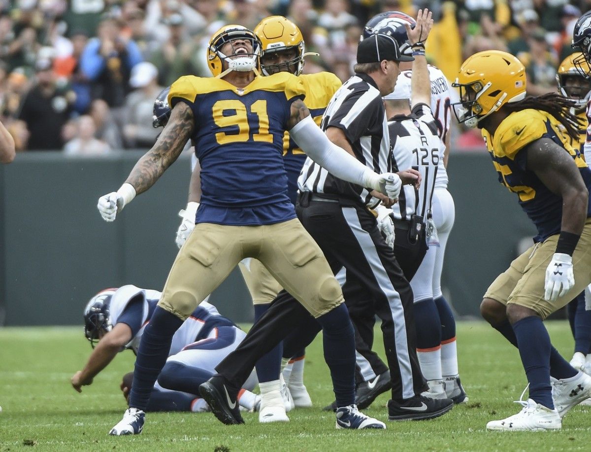 Green Bay Packers linebacker Preston Smith (91) reacts after sacking Denver Broncos quarterback Joe Flacco (5) in the first quarter at Lambeau Field.