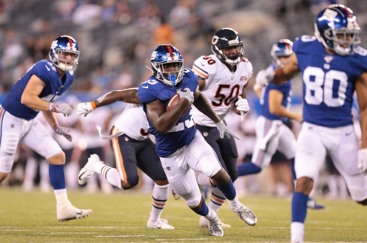 Aug 16, 2019; East Rutherford, NJ, USA; New York Giants running back Jon Hilliman (23) rushes for yards as Chicago Bears linebacker Chuck Harris (50) pursues during the second half at MetLife Stadium.