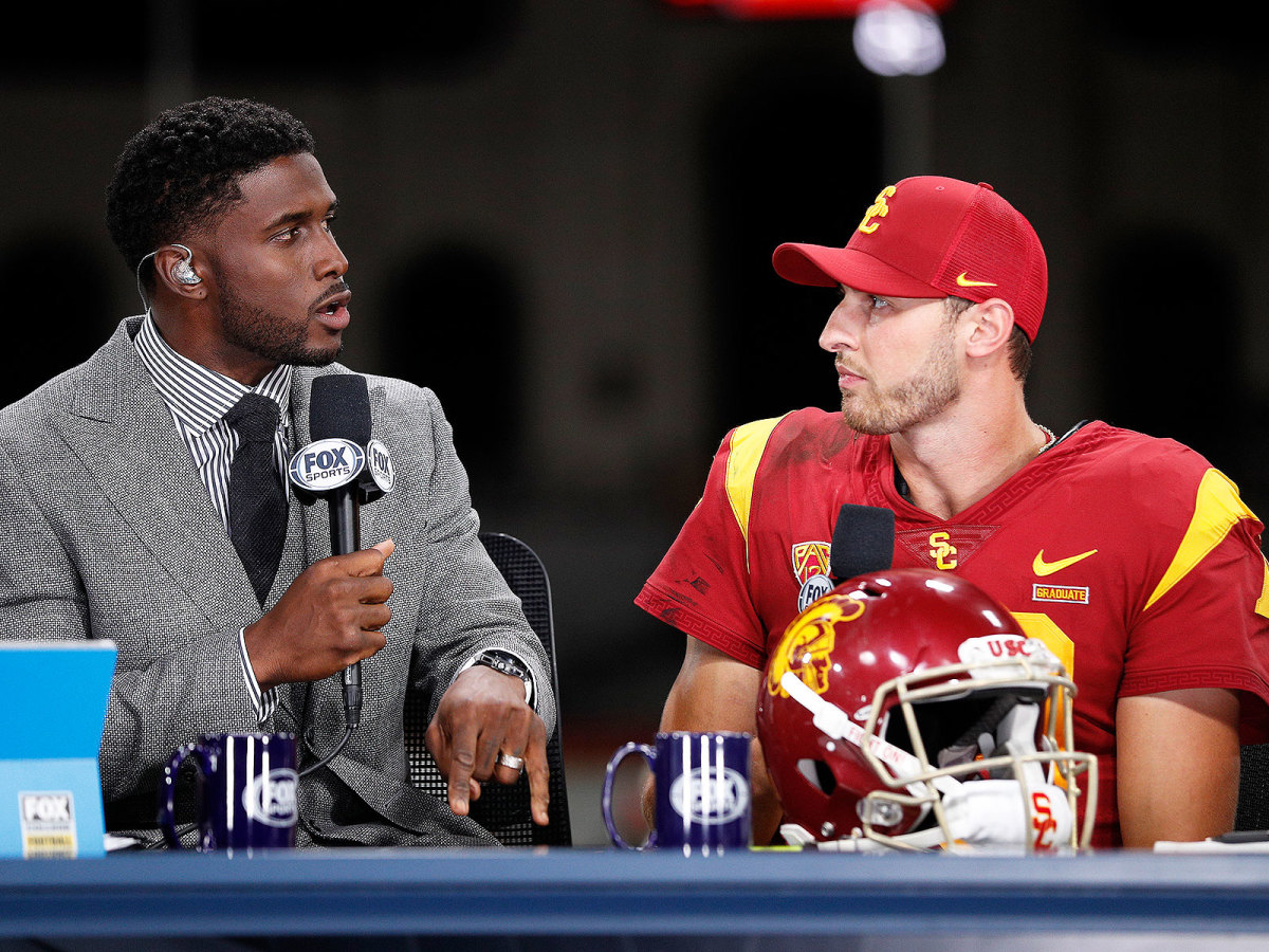 FOX Sports analyst and former USC star Reggie Bush interviews Trojans QB Matt Fink after the team's win over Utah.