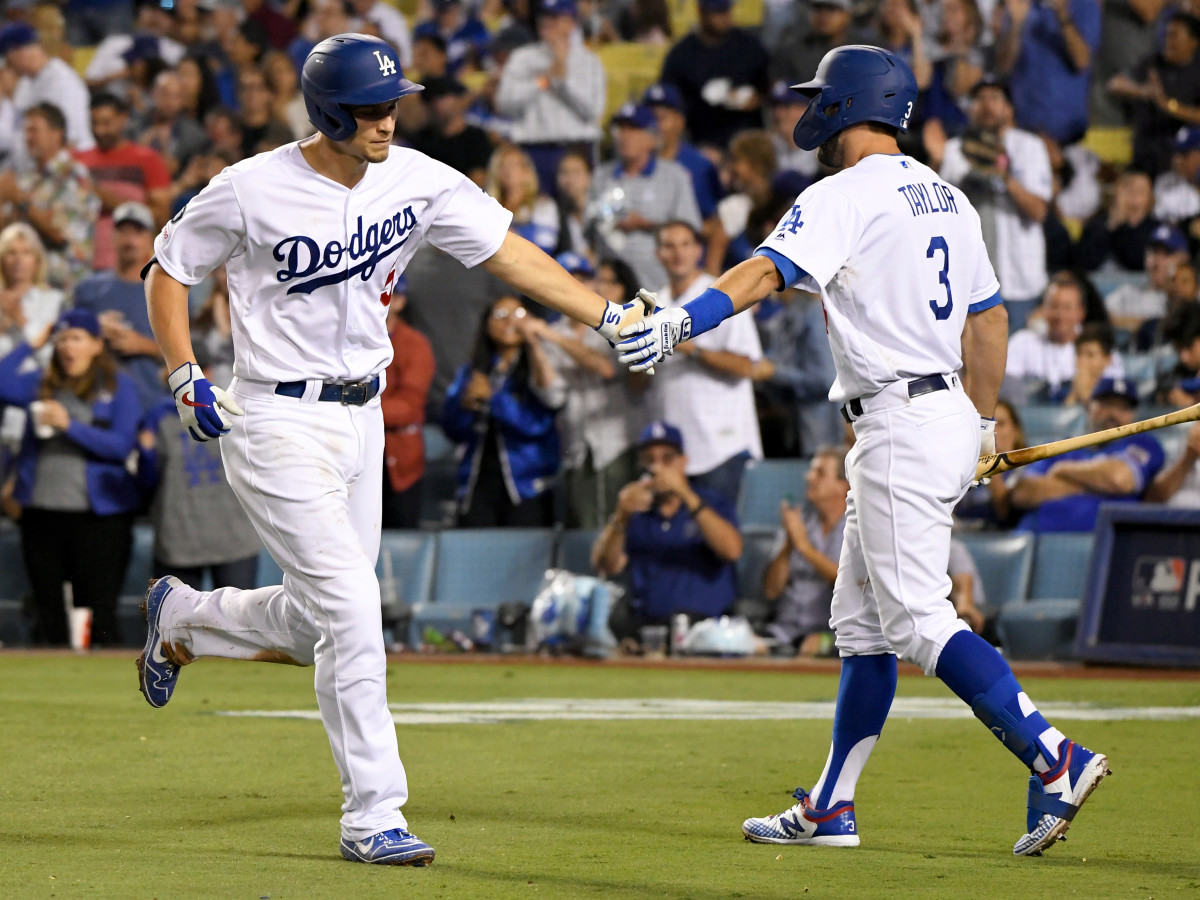 Corey Seager is greeted by Chris Tayler after Seager's three-run home run against the Colorado Rockies at Dodgers Stadium on Sept. 20, 2019, in Los Angeles, California. (John McCoy/Getty Images)