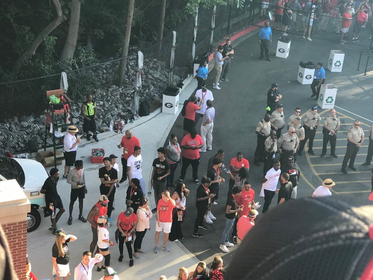 A group of basketball recruits, including Josh Taylor, enjoying the scene at the Dawg Walk.