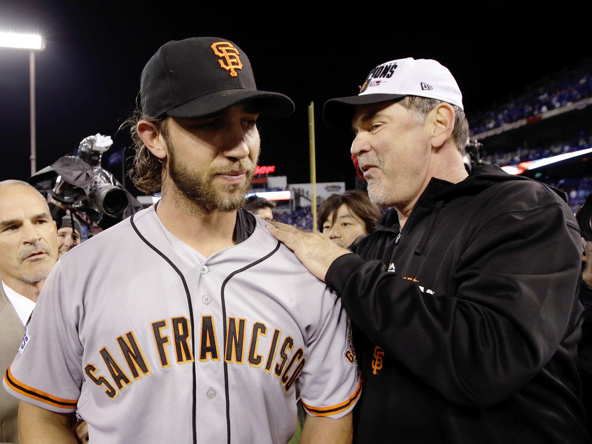 Manager Bruce Bochy #15 of the San Francisco Giants celebrates on the field with Madison Bumgarner #40 after defeating the Kansas City Royals 3-2 to win Game Seven of the 2014 World Series at Kauffman Stadium on October 29, 2014 in Kansas City, Missouri. (Photo by Ezra Shaw/Getty Images)