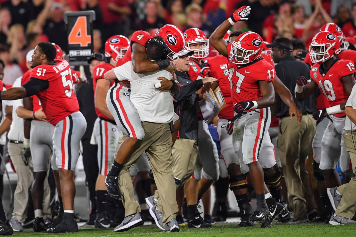 Georgia OLB, Nolan Smith celebrates with DC Dan Lanning