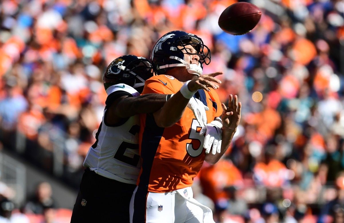 Jacksonville Jaguars defensive back D.J. Hayden (25) hits Denver Broncos quarterback Joe Flacco (5) in the first quarter at Empower Field at Mile High.