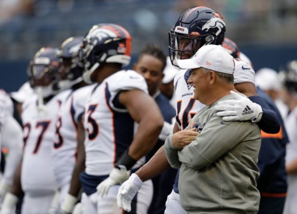 Denver Broncos wide receiver Courtland Sutton (14) stands with coach Vic Fangio, right, before the team's NFL football preseason game against the Seattle Seahawks in Seattle. While everyone else was zigging, general manager John Elway was zagging, hiring a 61-year-old defensive minded head coach in Fangio while other teams searched for the next offensive guru.