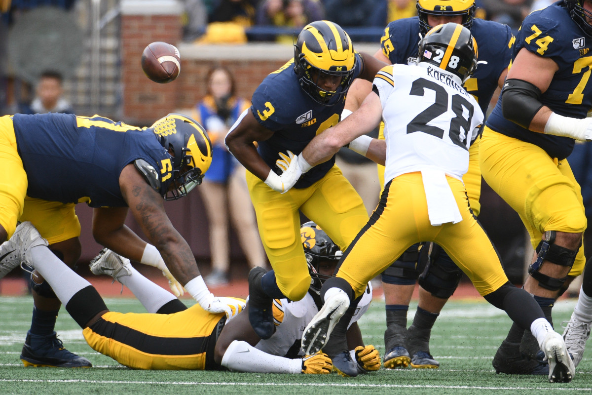Iowa safety Jack Koerner (28) forces Michigan running back Christian Turner (3) to fumble in Saturday's game.