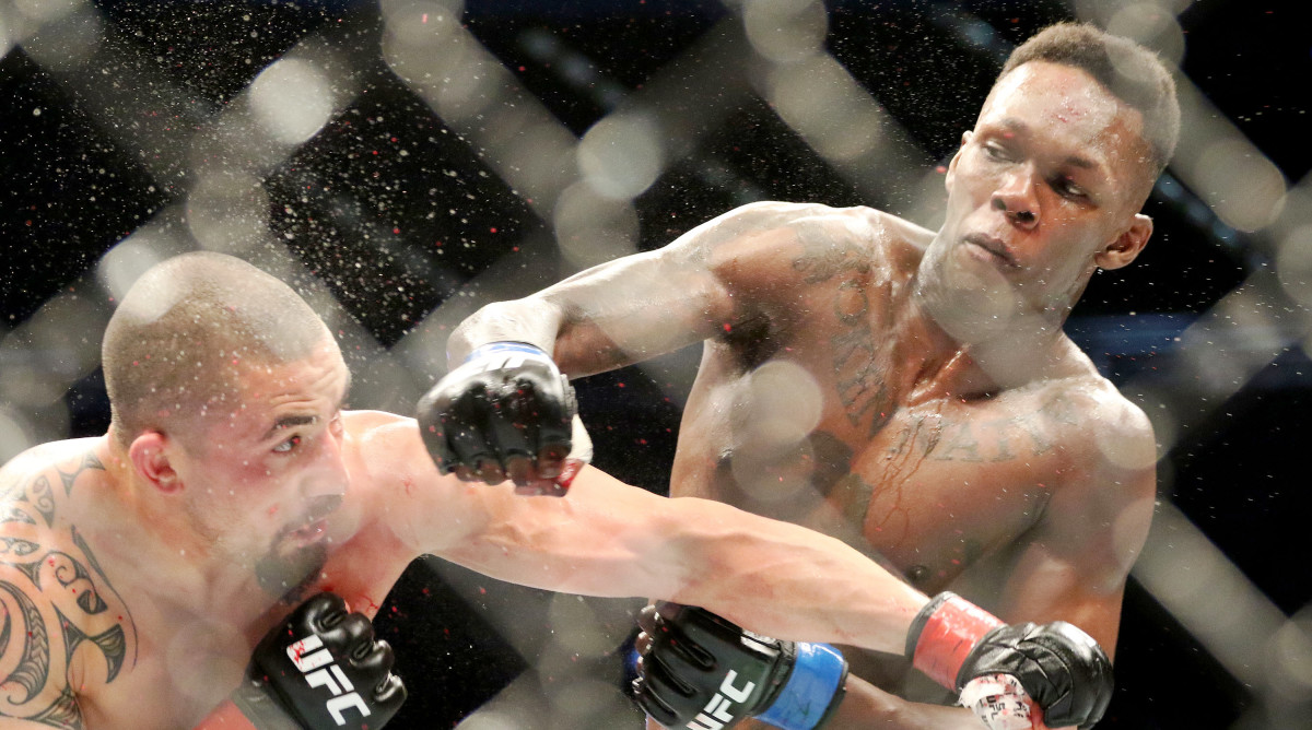 Oct 5, 2019; Melbourne, AUSTRALIA; Israel Adesanya (blue gloves) and Robert Whittaker (red gloves) during UFC 243 at Marvel Stadium. Mandatory Credit: Jasmin Frank-USA TODAY Sports