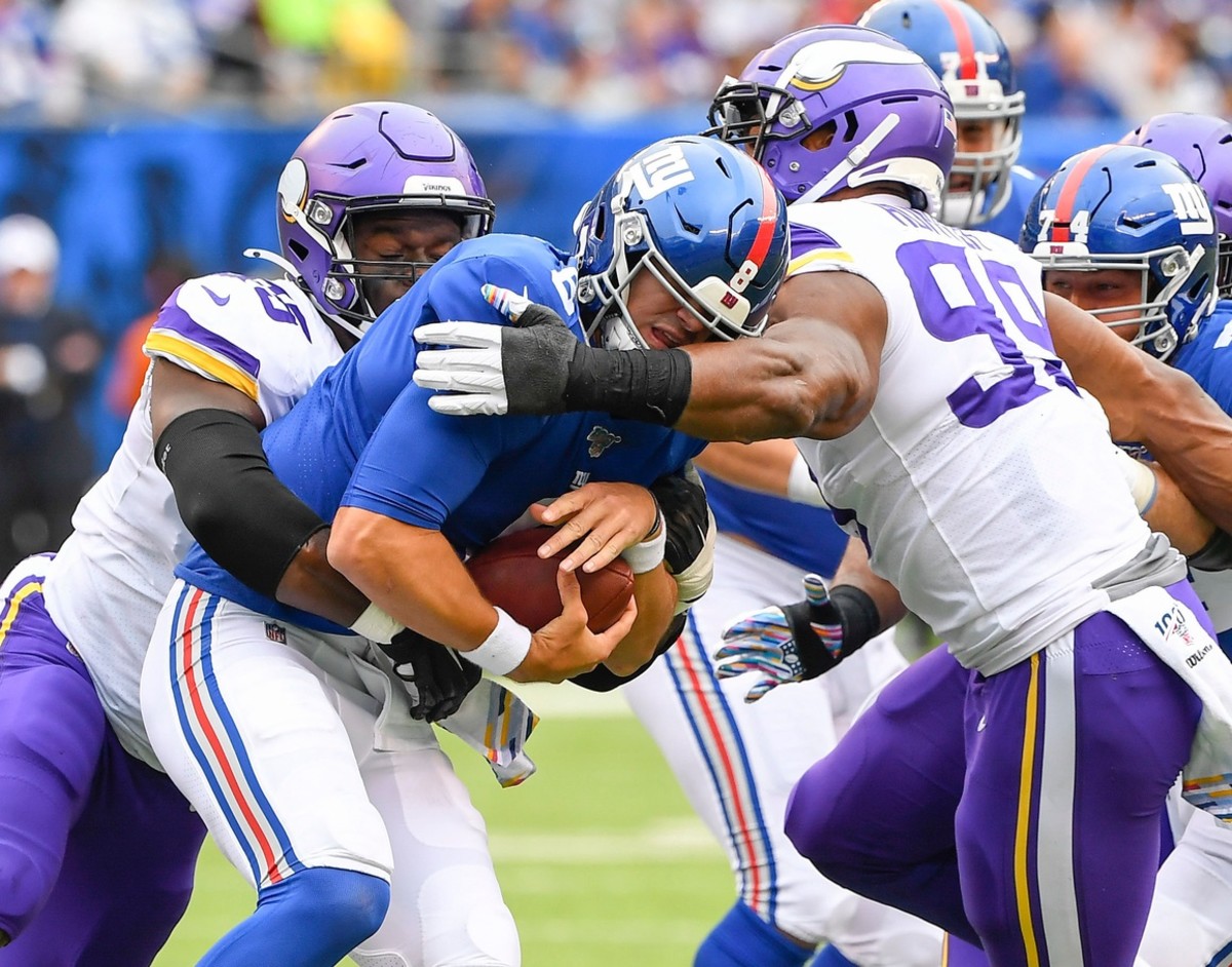 Oct 6, 2019; East Rutherford, NJ, USA; New York Giants quarterback Daniel Jones (8) is sacked by Minnesota Vikings defensive ends Ifeadi Odenigbo (95) and Danielle Hunter (99) in the 1st half at MetLife Stadium.