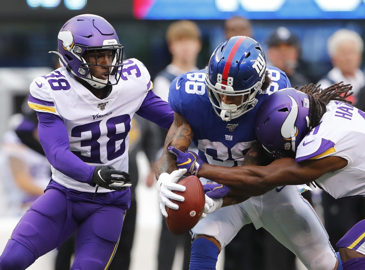 Oct 6, 2019; East Rutherford, NJ, USA; Minnesota Vikings defensive back Kris Boyd (38) and defensive back Anthony Harris (41) knock the ball out of the hands of New York Giants tight end Evan Engram (88) during the second half at MetLife Stadium.