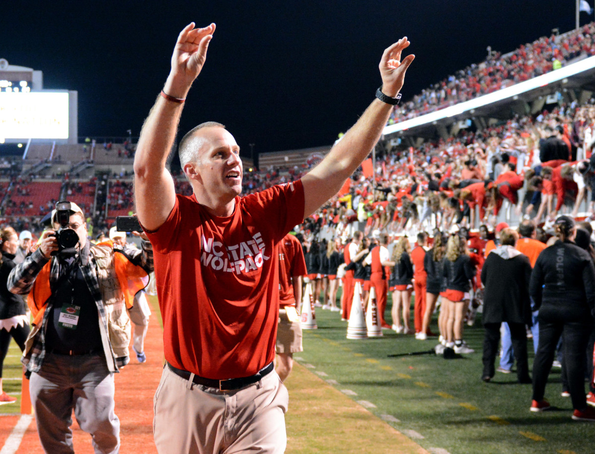 Wolfpack coach Dave Doeren acknowledges the crowd during a night game at Carter-Finley Stadium