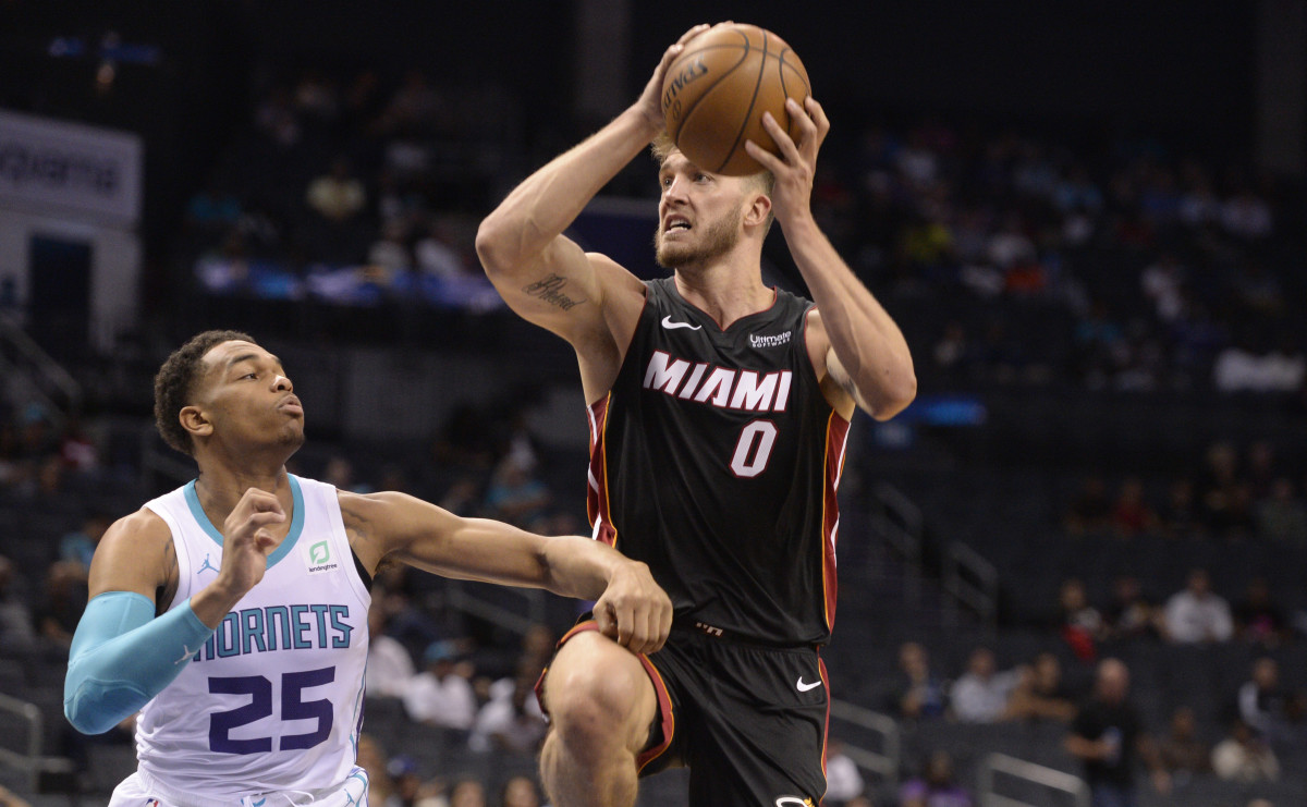 Miami Heat forward center Meyers Leonard (0) drives in as he is defended by Charlotte Hornets forward P.J. Washington (25) during the first half at the Spectrum Center. (Sam Sharpe-USA TODAY Sports)