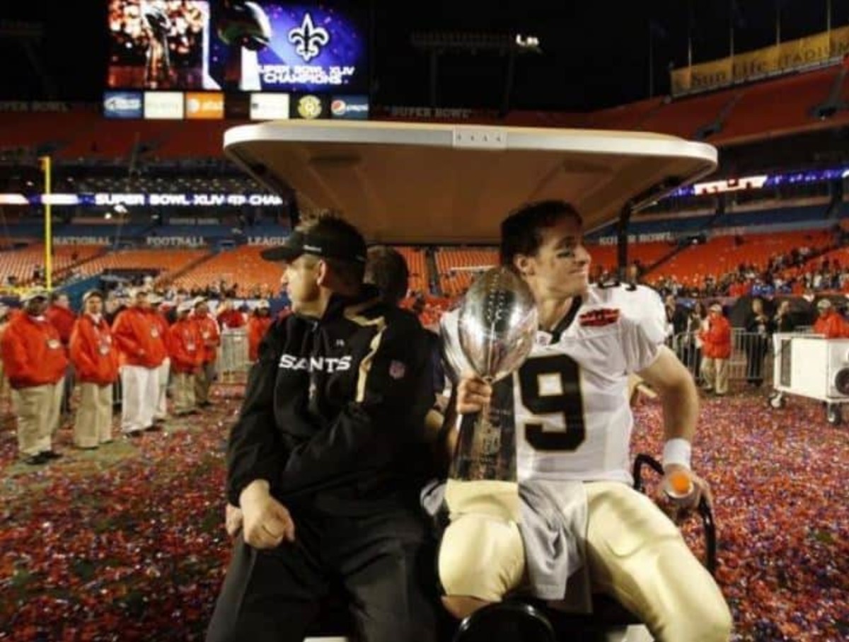  Feb 7, 2010 ; Miami Gardens, FL, USA; New Orleans Saints head coach Sean Payton shares a ride with quarterback Drew Brees (9) (holding the Lombardi Trophy) as they leave the field after defeating the Indianapolis Colts 31-17 in Super Bowl XLIV at Sun Life Stadium in Miami Gardens, Florida. Mandatory Credit: Matthew Emmons-US PRESSWIRE