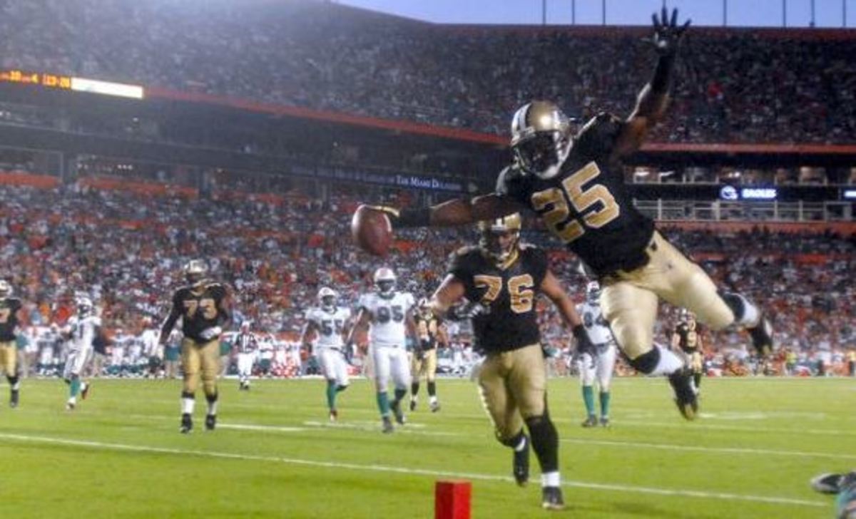  Oct 25, 2009 ; Miami Gardens, FL, USA; New Orleans Saints running back Reggie Bush (25) leaps across the goal line for a touchdown against the Miami Dolphins during the fourth quarter of a game at Sun Life Stadium in Miami Gardens, Florida. Mandatory Credit: Steve Mitchell-USA TODAY Sports