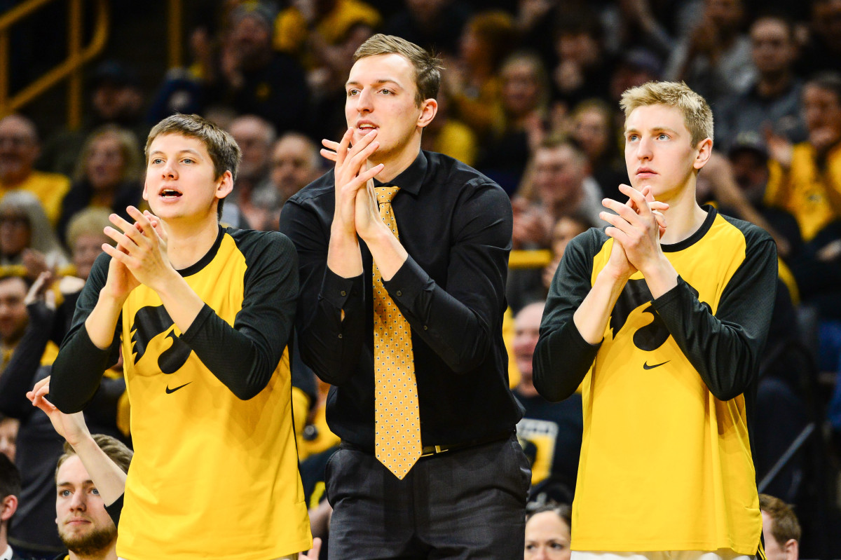 Iowa's Jack Nunge (center) cheers from the bench during a game last season.