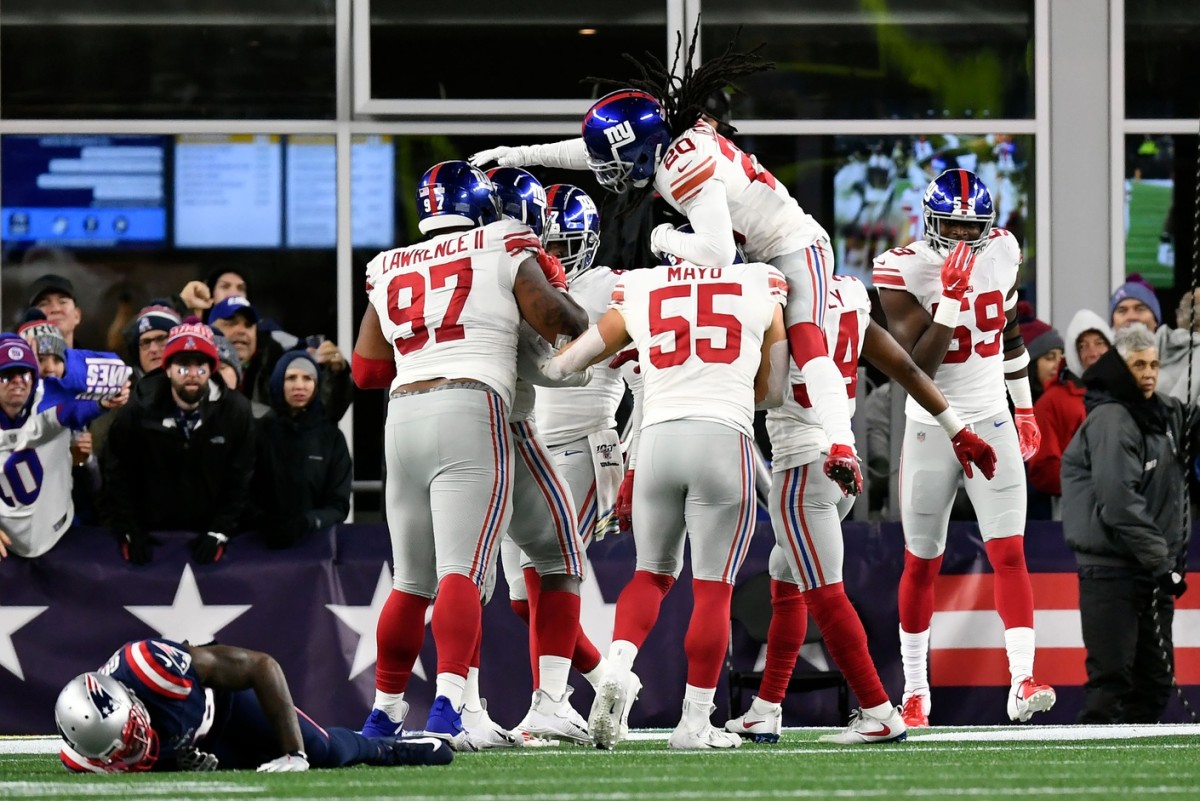 Oct 10, 2019; Foxborough, MA, USA; The New York Giants celebrate a touchdown scored by New York Giants linebacker Markus Golden (44) in front of New England Patriots wide receiver Josh Gordon (10) during the first half at Gillette Stadium.