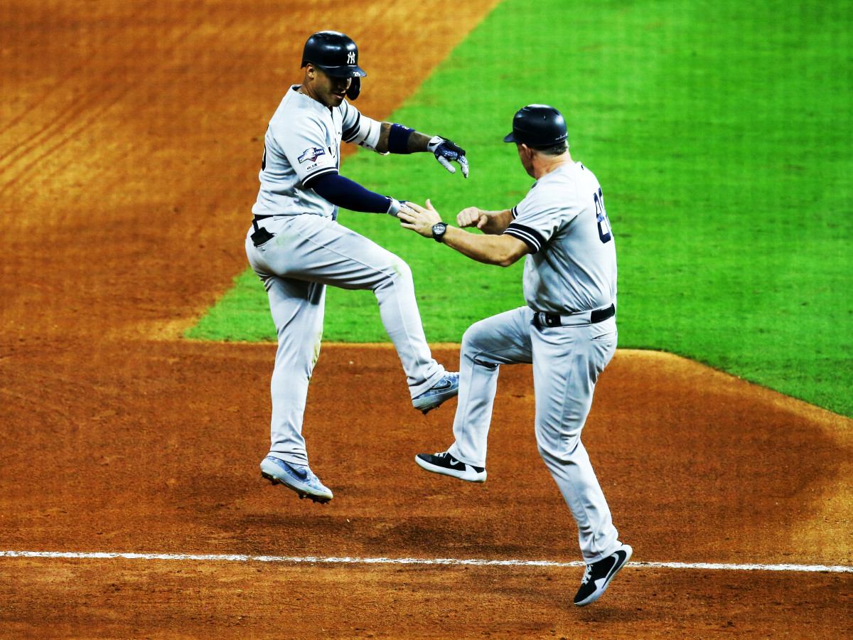 Oct 12, 2019; Houston, TX, USA; New York Yankees second baseman Gleyber Torres (25) celebrates with third base coach Phil Nevin (88) after hitting a solo home run in the sixth inning in game one of the 2019 ALCS playoff baseball series at Minute Maid Park. Mandatory Credit: Thomas B. Shea-USA TODAY Sports