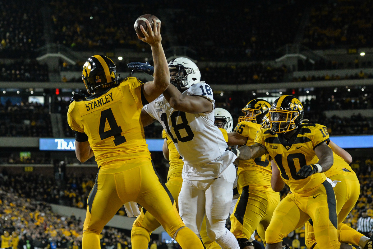 Iowa quarterback Nate Stanley (4) has his pass altered by Penn State defensive end Shaka Toney (18) during the third quarter of Saturday's game.
