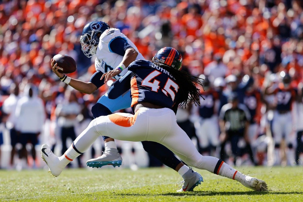Denver Broncos linebacker Alexander Johnson (45) sacks Tennessee Titans quarterback Marcus Mariota (8) in the first quarter at Empower Field at Mile High.