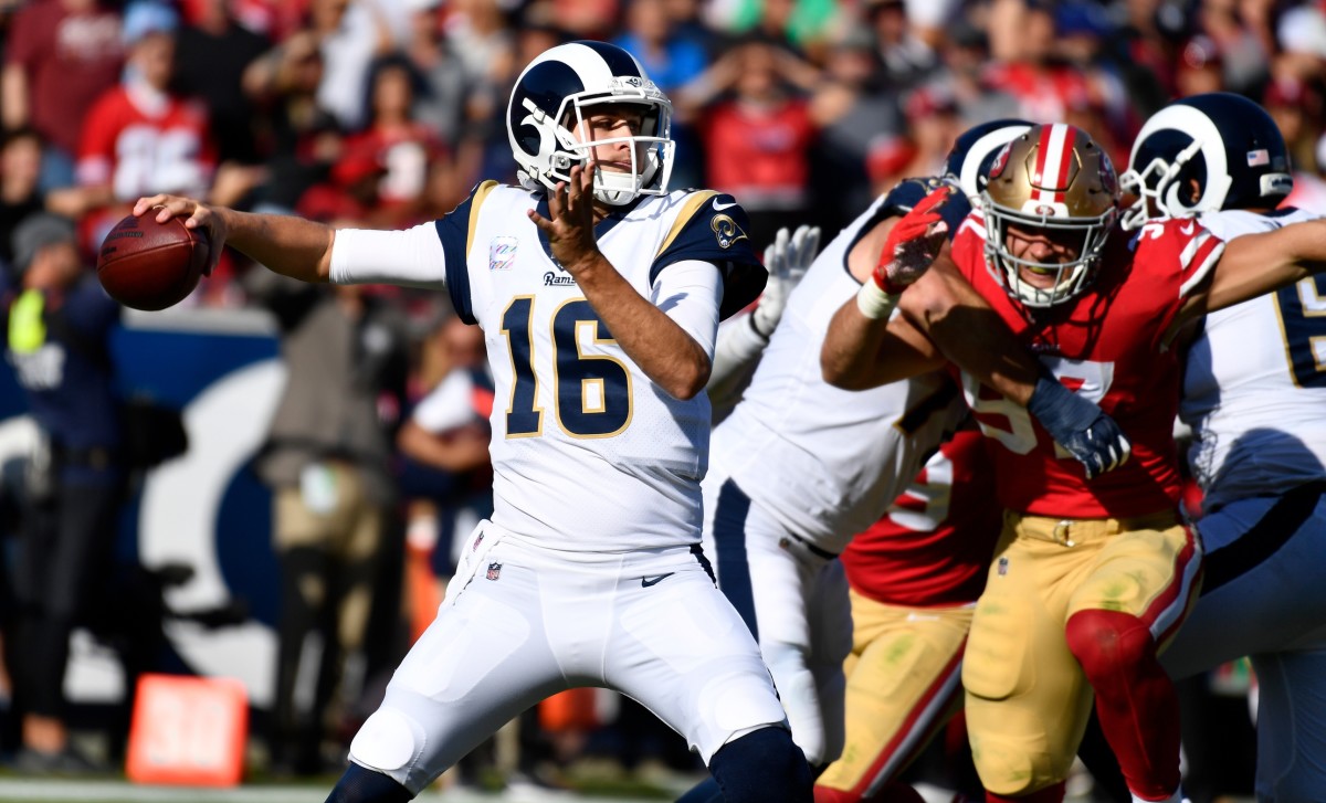 Los Angeles Rams quarterback Jared Goff (16) throws a pass under pressure from San Francisco 49ers defensive end Nick Bosa (97) during the fourth quarter at Los Angeles Memorial Coliseum.