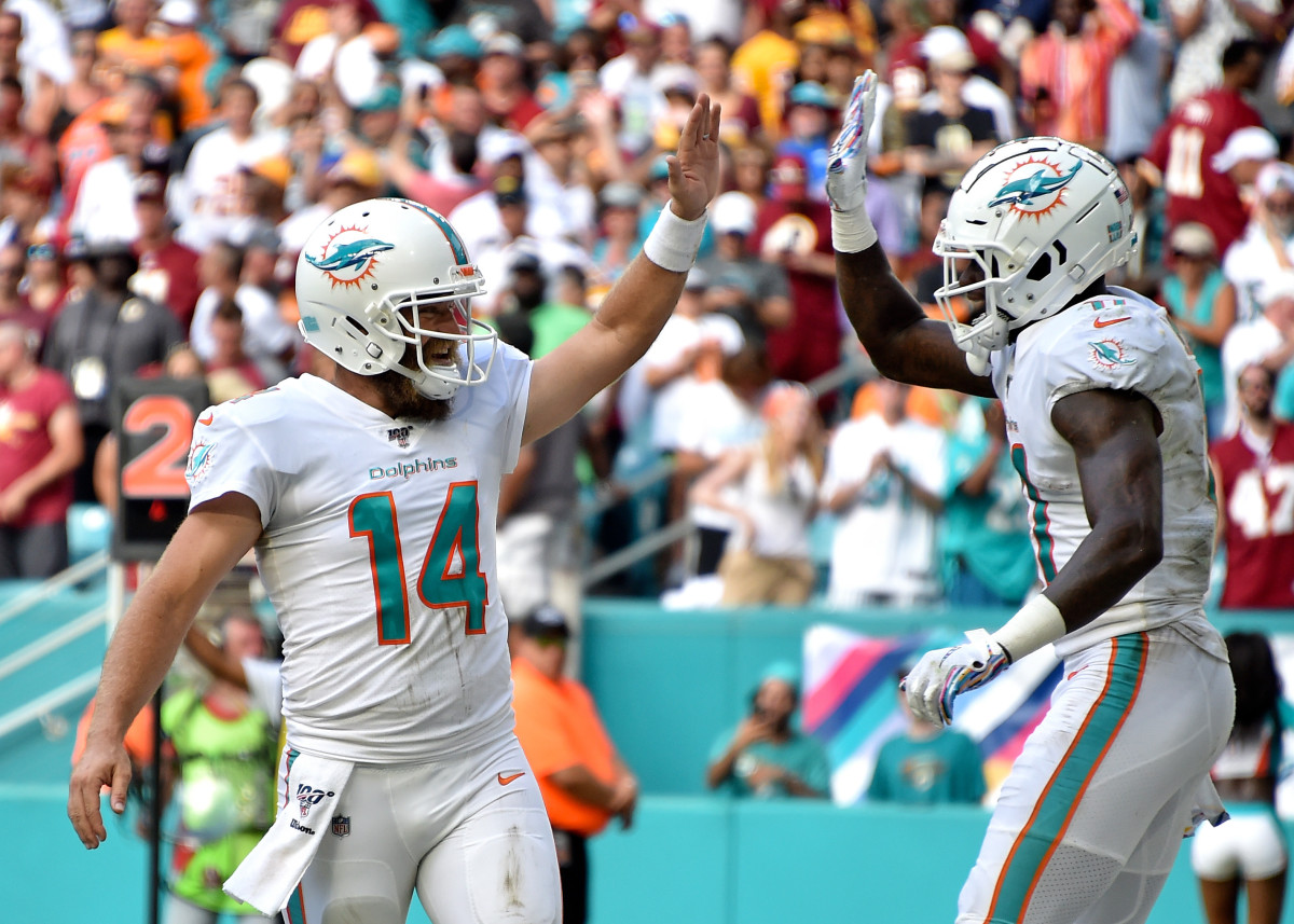 Oct 13, 2019; Miami Gardens, FL, USA; Miami Dolphins quarterback Ryan Fitzpatrick (left) greets wide receiver DeVante Parker (right) on a touchdown catch against the Washington Redskins during the second half at Hard Rock Stadium. Mandatory Credit: Steve Mitchell-USA TODAY Sports