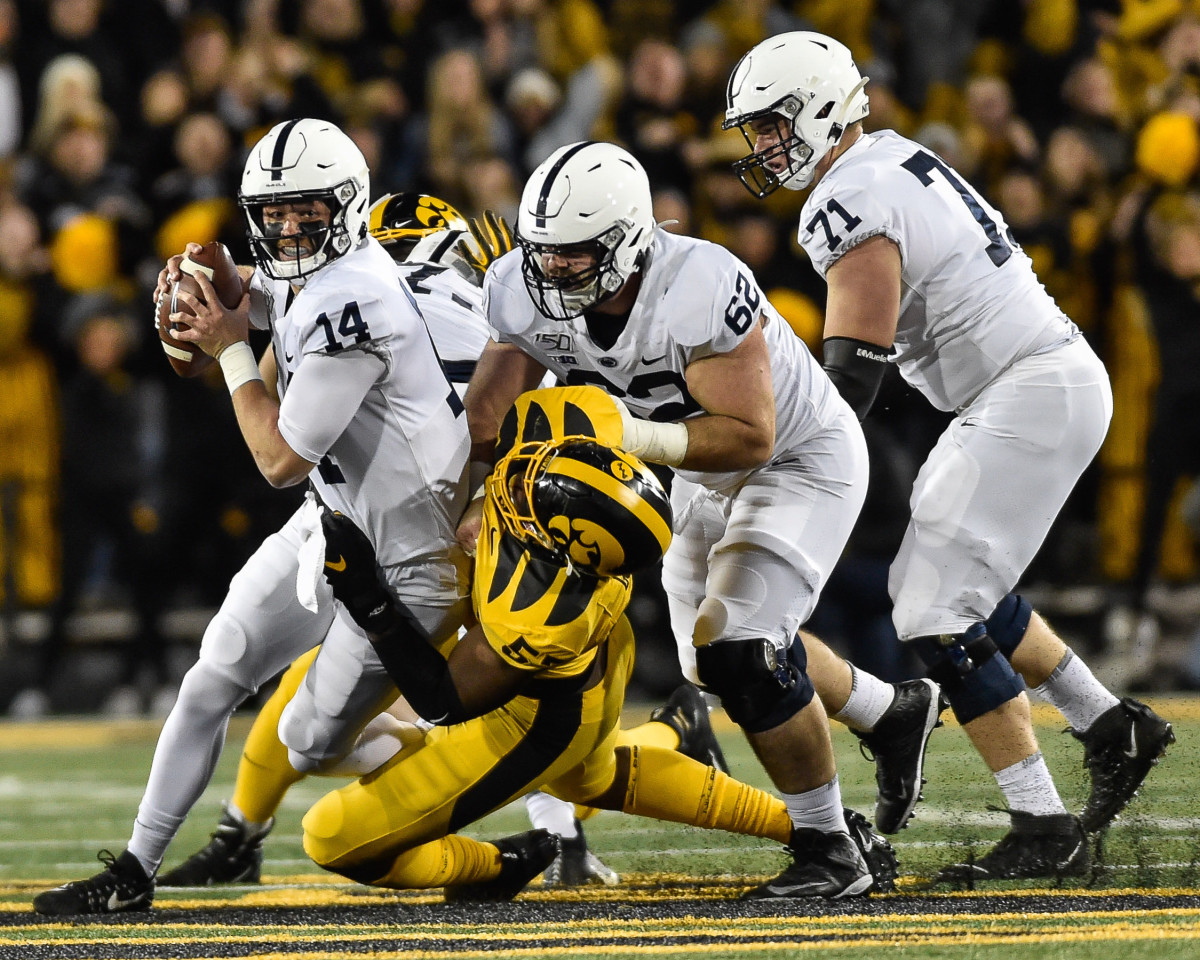 Penn State quarterback Sean Clifford (14) is sacked by Iowa defensive end Chauncey Golston in Saturday's game at Kinnick Stadium.