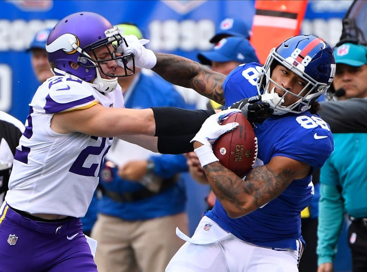 Oct 6, 2019; East Rutherford, NJ, USA; New York Giants tight end Evan Engram (88) gets a first down in the first quarter as Minnesota Vikings free safety Harrison Smith (22) defends at MetLife Stadium.