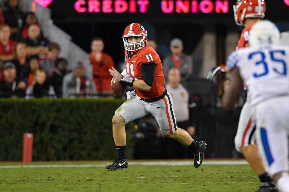 Jake Fromm scrambles for a gain against Kentucky in 2017.