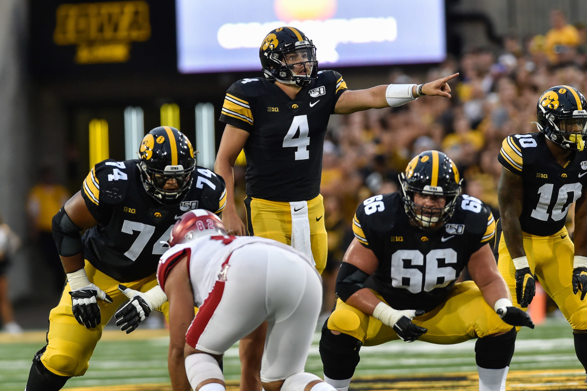 Tristan Wirfs (74) and Levi Paulsen (66) get ready as quarterback Nate Stanley (4) calls out signals in Iowa's season opener against Miami (Ohio).