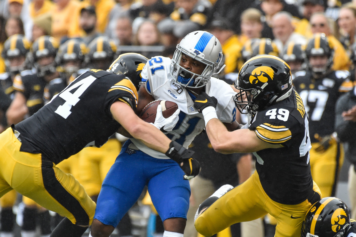 Iowa linebackers Nick Niemann (49) and Kristian Welch tackle Middle Tennessee State running back Jayy McDonald in the Sept. 28 game.