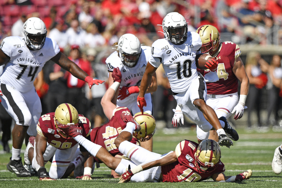 Louisville Cardinals running back Javian Hawkins (10) hurdles over three fallen Boston College defenders during a game earlier this season (Jamie Rhodes/USA TODAY Sports)