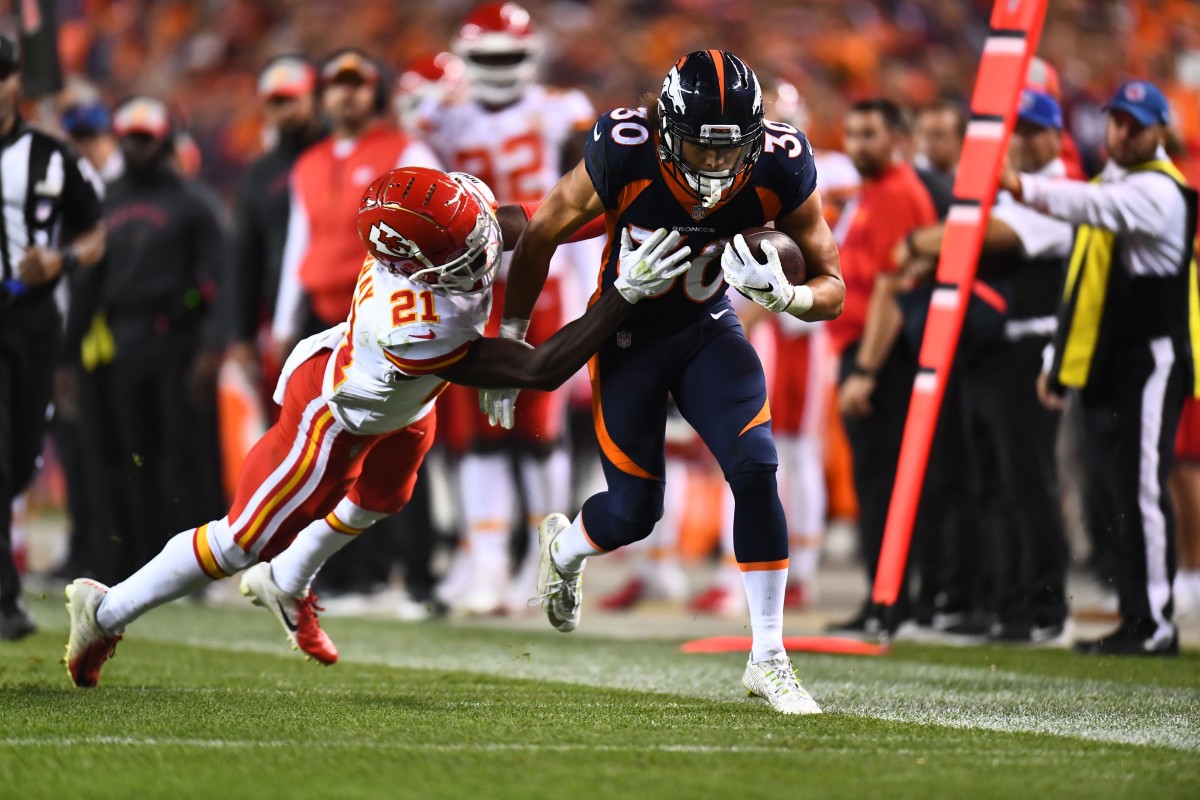 Oct 1, 2018; Denver, CO, USA; Denver Broncos running back Phillip Lindsay (30) carries the ball against Kansas City Chiefs cornerback Eric Murray (21) in the third quarter against the at Broncos Stadium at Mile High.