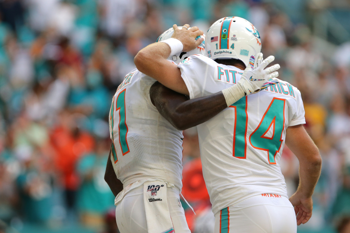 Oct 13, 2019; Miami Gardens, FL, USA; Miami Dolphins quarterback Ryan Fitzpatrick (14) celebrates with Miami Dolphins wide receiver DeVante Parker (11) after scoring a touchdown in the fourth quarter of the game against the Washington Redskins at Hard Rock Stadium. Mandatory Credit: Sam Navarro-USA TODAY Sports