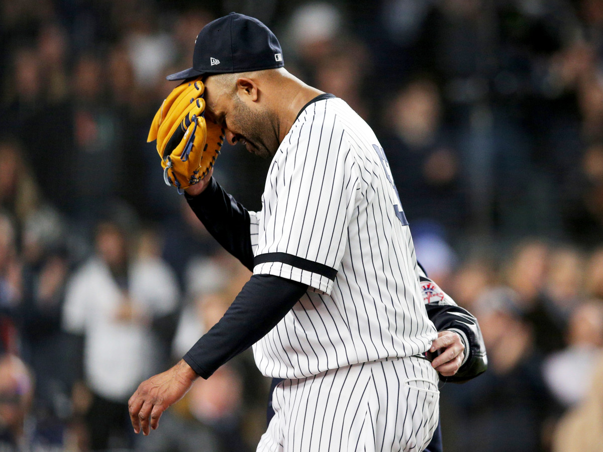 Oct 17, 2019; Bronx, NY, USA; New York Yankees pitcher CC Sabathia (52) reacts as he is walked off the field by trainer Steve Donohue after suffering an apparent injury against the Houston Astros during the eighth inning of game four of the 2019 ALCS playoff baseball series at Yankee Stadium. Mandatory Credit: Brad Penner-USA TODAY Sports