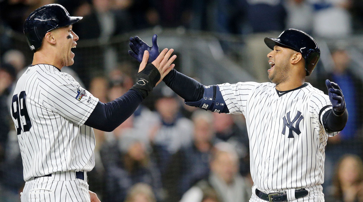 New York Yankees fans hold up signs supporting Yankees manager Joe Torre in  the first inning against the Cleveland Indians during game 3 of the ALDS  against the New York Yankees at