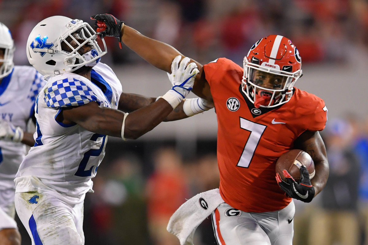 D'andre Swift fends off a Kentucky defender in 2017.