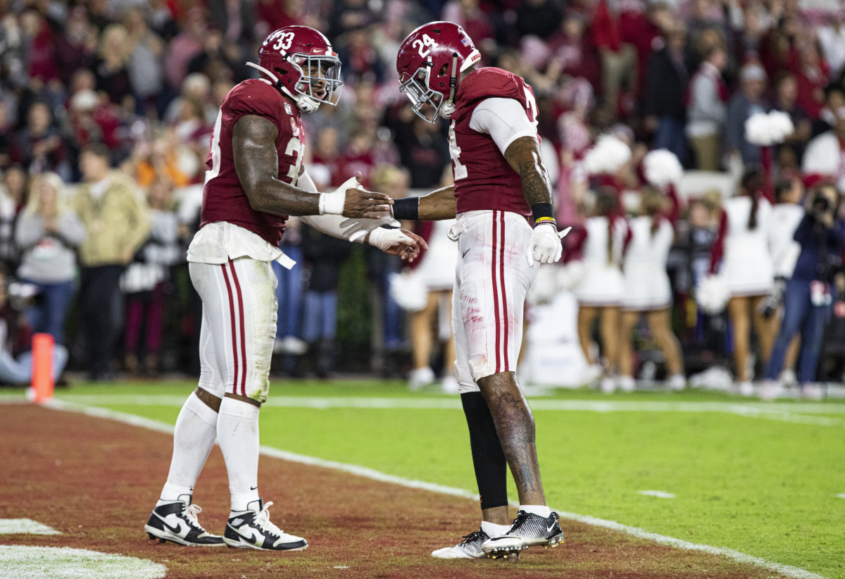 Anfernee Jennings and Terrell Lewis celebrate a sack against Tennessee