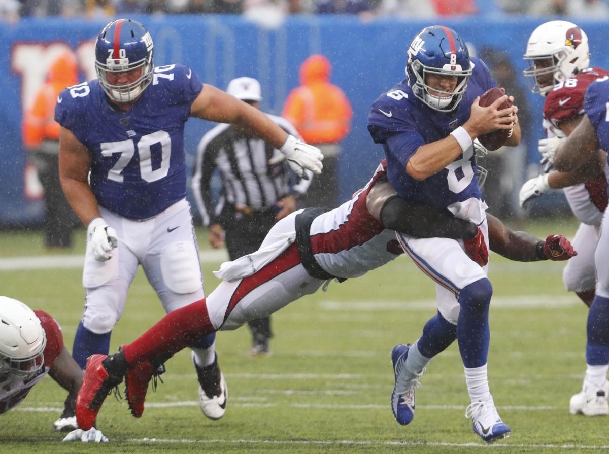 Oct 20, 2019; East Rutherford, NJ, USA; New York Giants quarterback Daniel Jones (8) rushes for yardage before being tackled by Arizona Cardinals linebacker Chandler Jones (55) during the second half at MetLife Stadium.