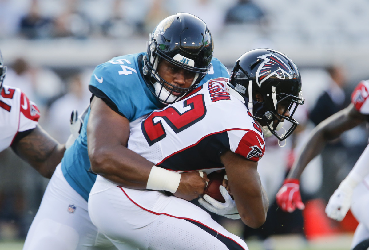 Aug 29, 2019; Jacksonville, FL, USA; Atlanta Falcons running back Qadree Ollison (32) is tackled by Jacksonville Jaguars defensive tackle Eli Ankou (54) during the first quarter at TIAA Bank Field. Mandatory Credit: Reinhold Matay-USA TODAY Sports