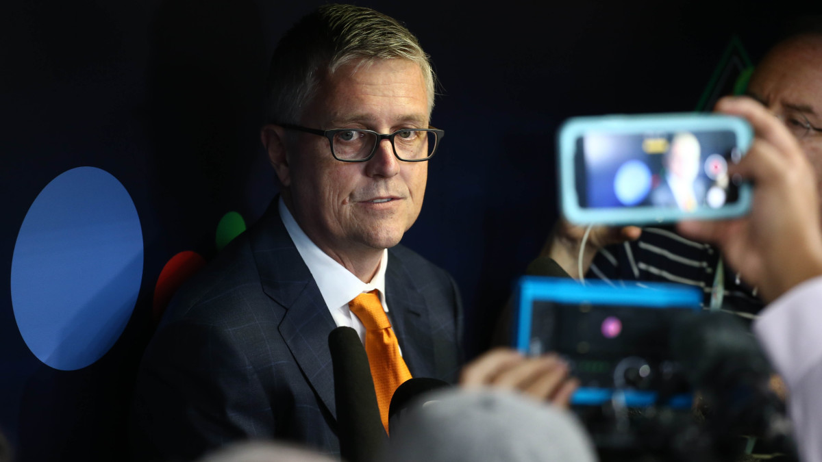 Houston Astros general manager Jeff Luhnow fields questions from reporters before a playoff game.