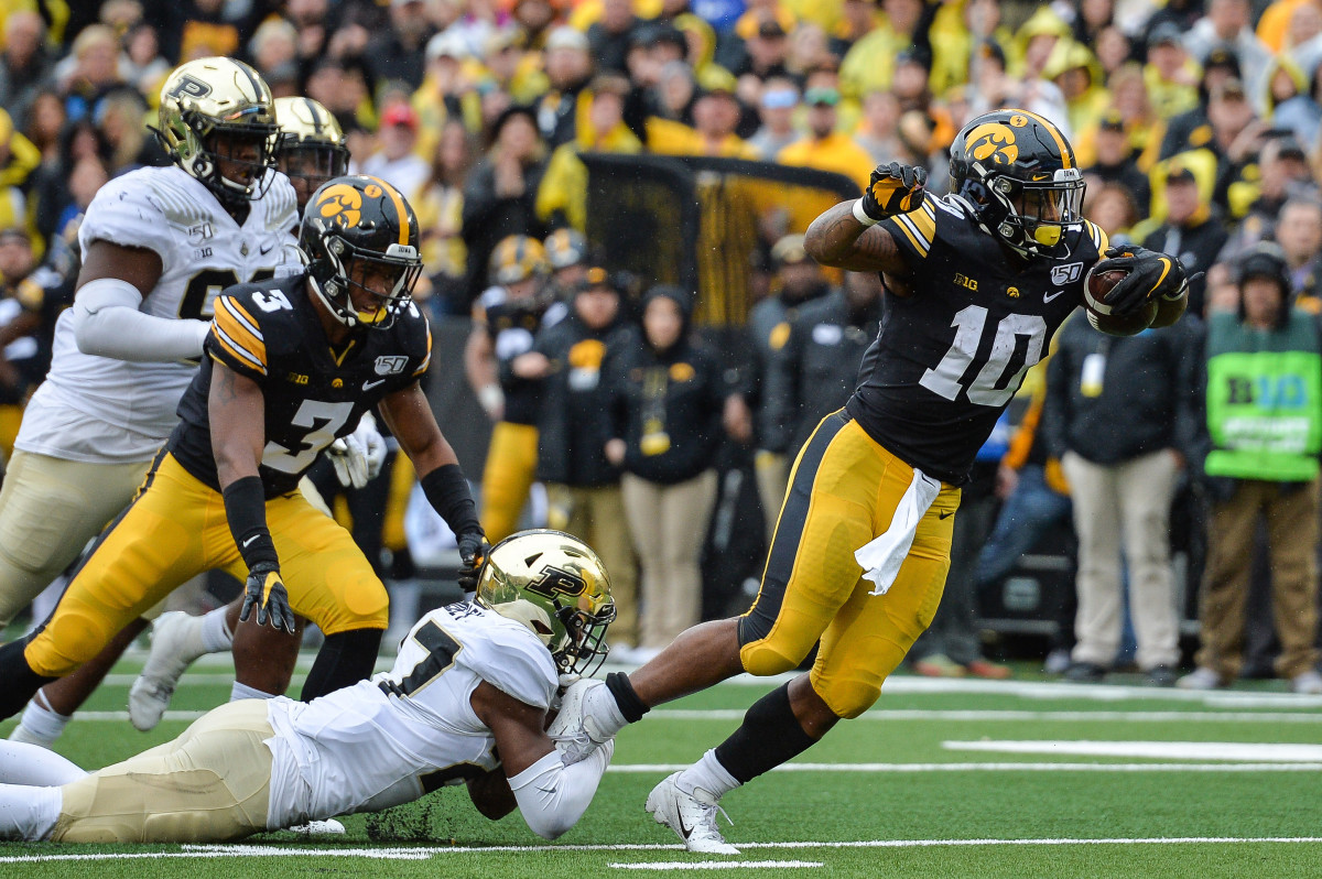 Iowa running back Mekhi Sargent (10) carries the ball past Purdue safety Navon Mosley (27) to score a touchdown during the fourth quarter of Saturday's game at Kinnick Stadium.