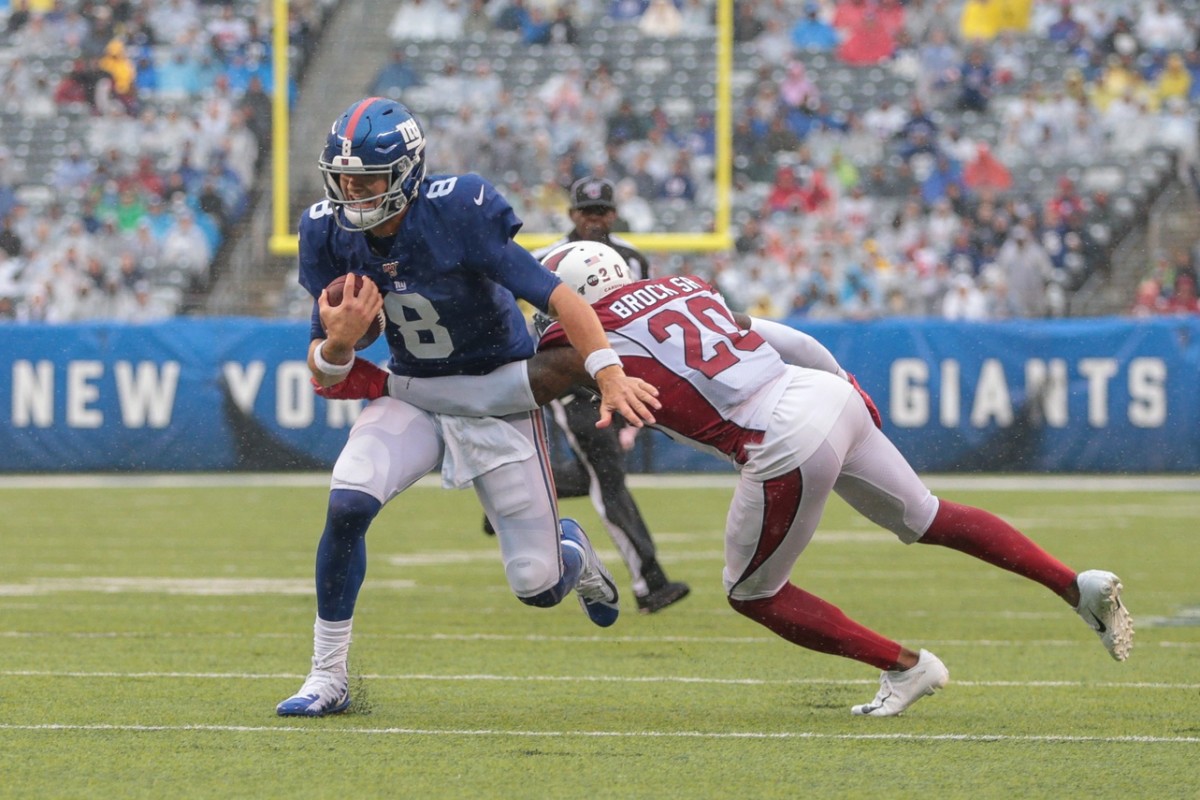 Oct 20, 2019; East Rutherford, NJ, USA; New York Giants quarterback Daniel Jones (8) carries the ball as Arizona Cardinals defensive back Tramaine Brock (20) tackles during the second half at MetLife Stadium.