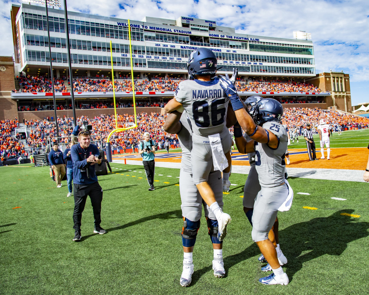 Teammates celebrate Illinois Fighting Illini wide receiver Donny Navarro's touchdown during the first half against the Wisconsin Badgers at Memorial Stadium.