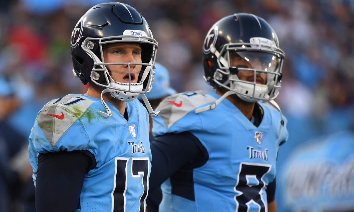 Tennessee Titans quarterback Ryan Tannehill (17) and quarterback Marcus Mariota (8) look on from the sidelines during the second half against the Los Angeles Chargers at Nissan Stadium.