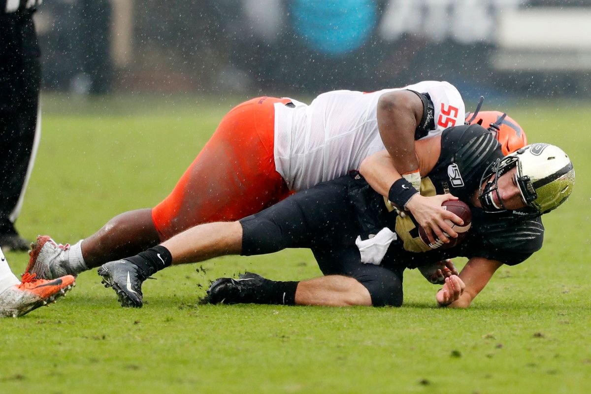Purdue quarterback Jack Plummer (13) is tackled by Illinois defensive lineman Jamal Milan (55) during the second quarter of the Illini's 24-6 win at Ross-Ade Stadium.