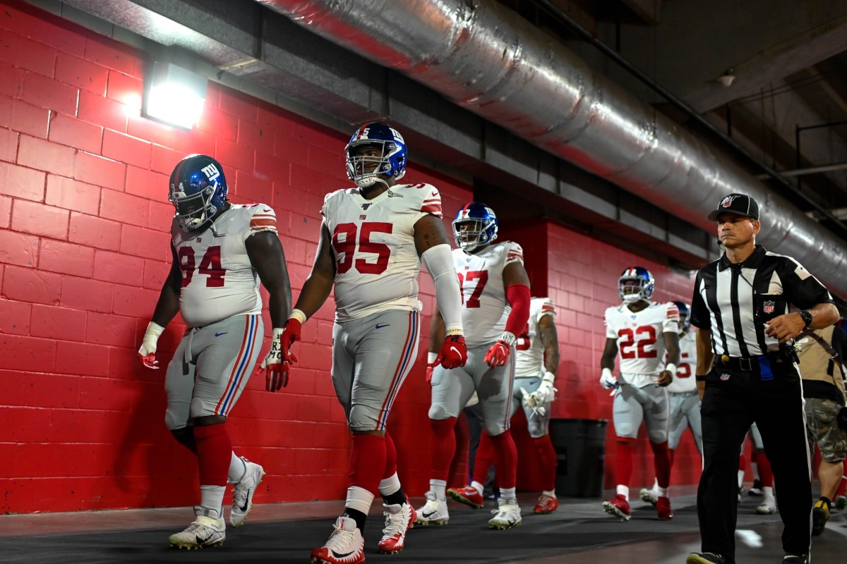 Sep 22, 2019; Tampa, FL, USA; New York Giants defensive end Dalvin Tomlinson (94) and defensive end B.J. Hill (95) walk through the tunnel prior to the game between the Tampa Bay Buccaneers and the New York Giants at Raymond James Stadium.