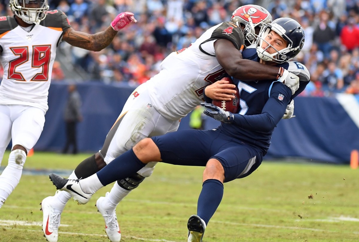 Tennessee Titans punter Brett Kern (6) is tackled by Tampa Bay Buccaneers linebacker Devin White (45) on a fake field goal attempt during the second half at Nissan Stadium.