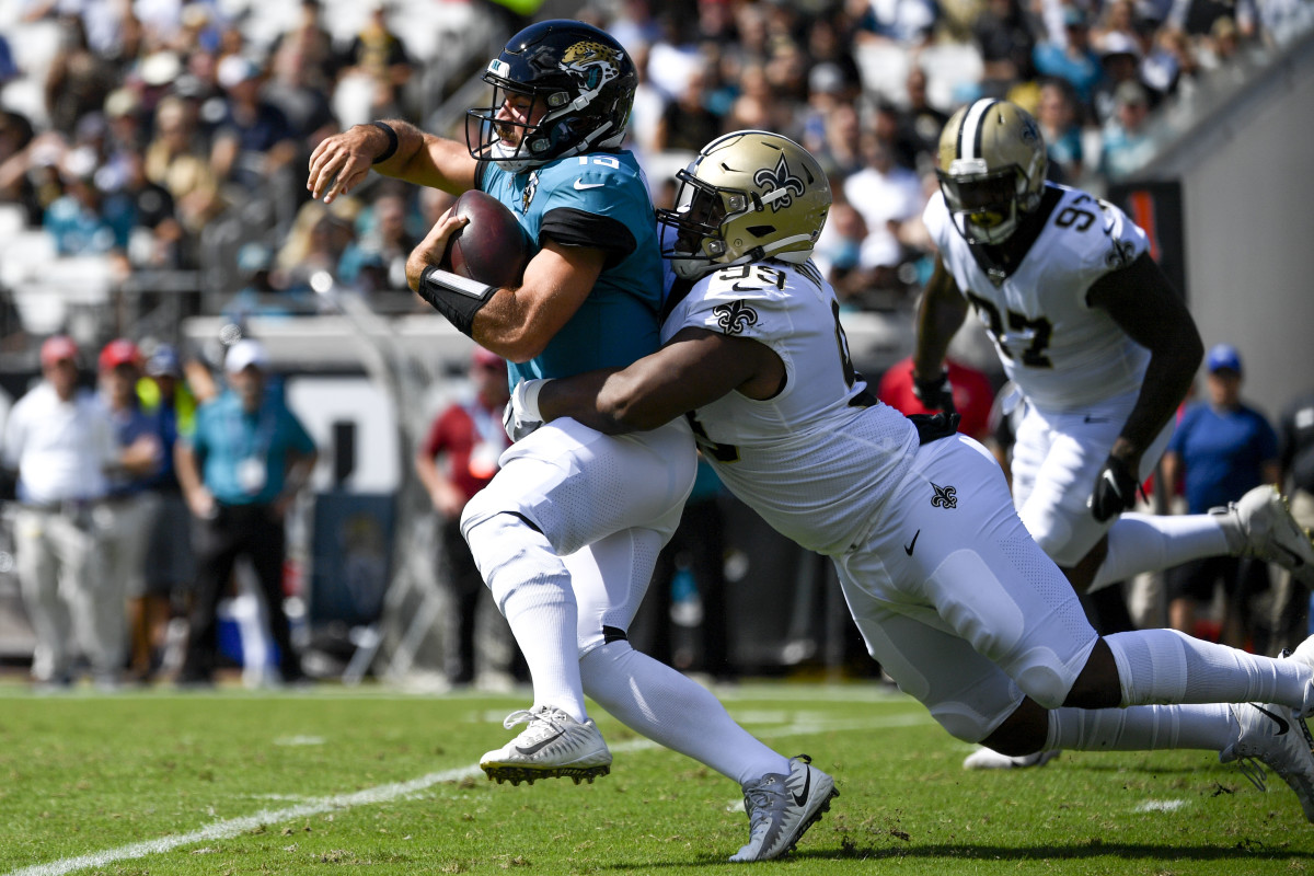 Oct 13, 2019; Jacksonville, FL, USA; Jacksonville Jaguars quarterback Gardner Minshew (15) scrambles with the ball against New Orleans Saints defensive tackle Shy Tuttle (99) during the first quarter at TIAA Bank Field. Mandatory Credit: Douglas DeFelice-USA TODAY Sports