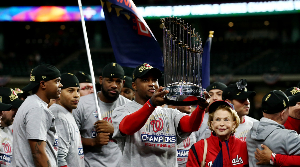 Oct 30, 2019; Houston, TX, USA; Washington Nationals left fielder Juan Soto hoists the Commissioners Trophy after defeating the Houston Astros in game seven of the 2019 World Series at Minute Maid Park. The Washington Nationals won the World Series winning four games to three. Mandatory Credit: Troy Taormina-USA TODAY Sports