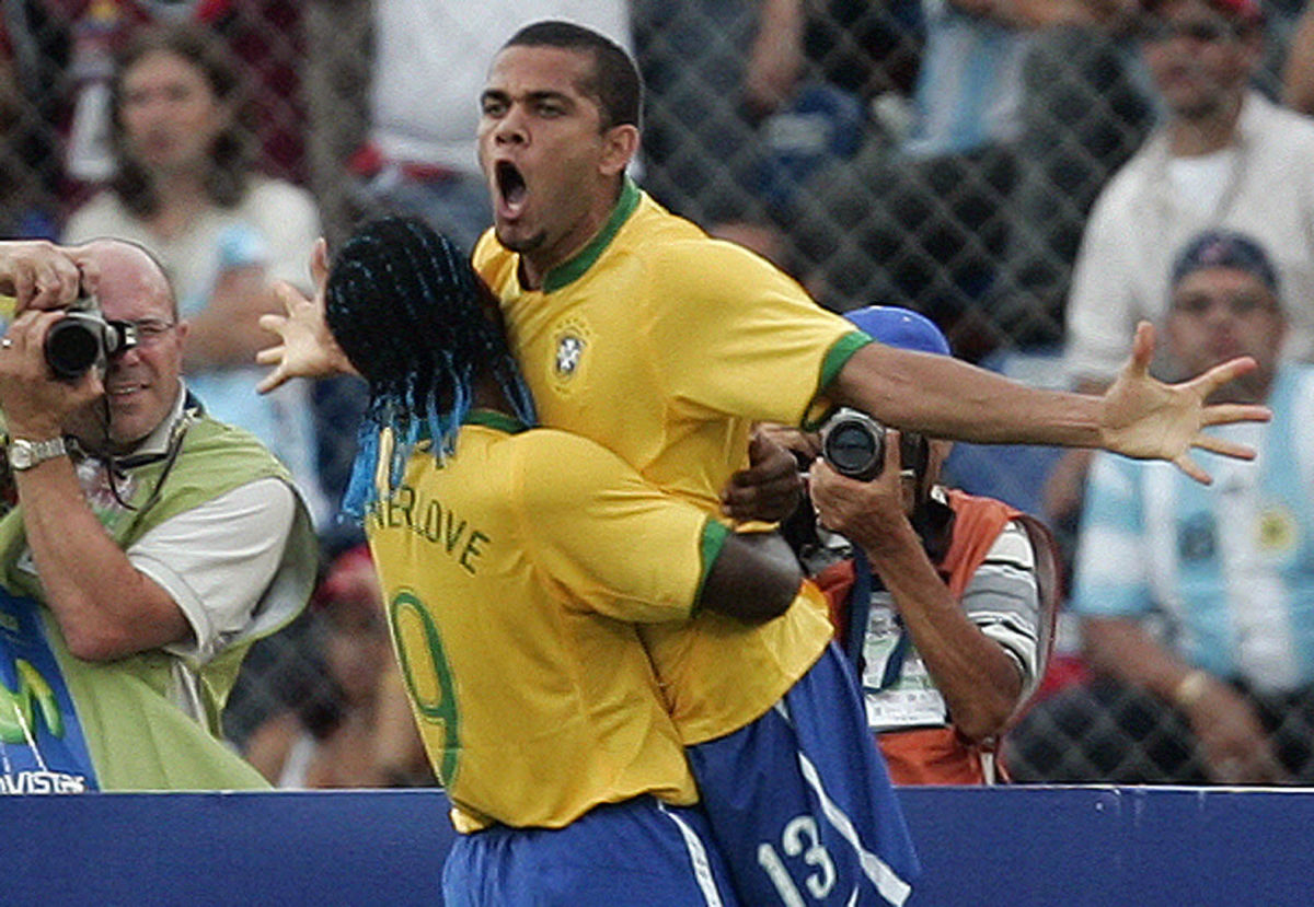 Brazilian defender Daniel Alves (up) cel...